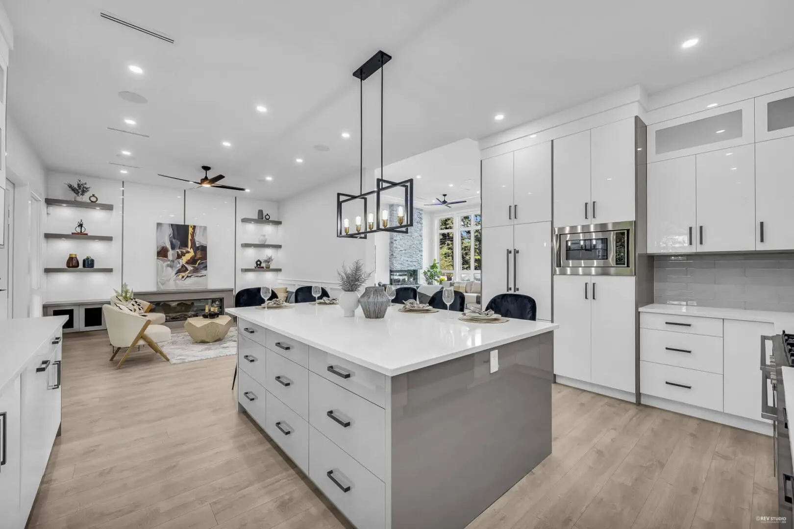 A kitchen with white cabinets and island in it