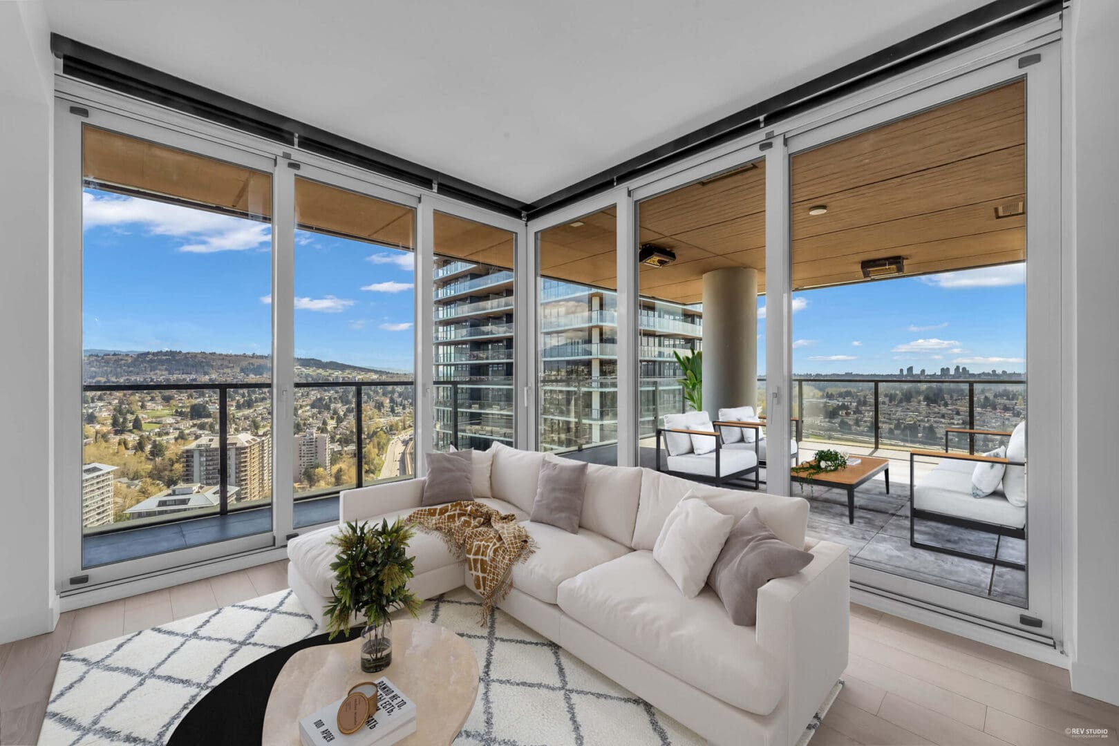 A living room with large windows and a couch