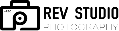 A black and white photo of the rev group logo.