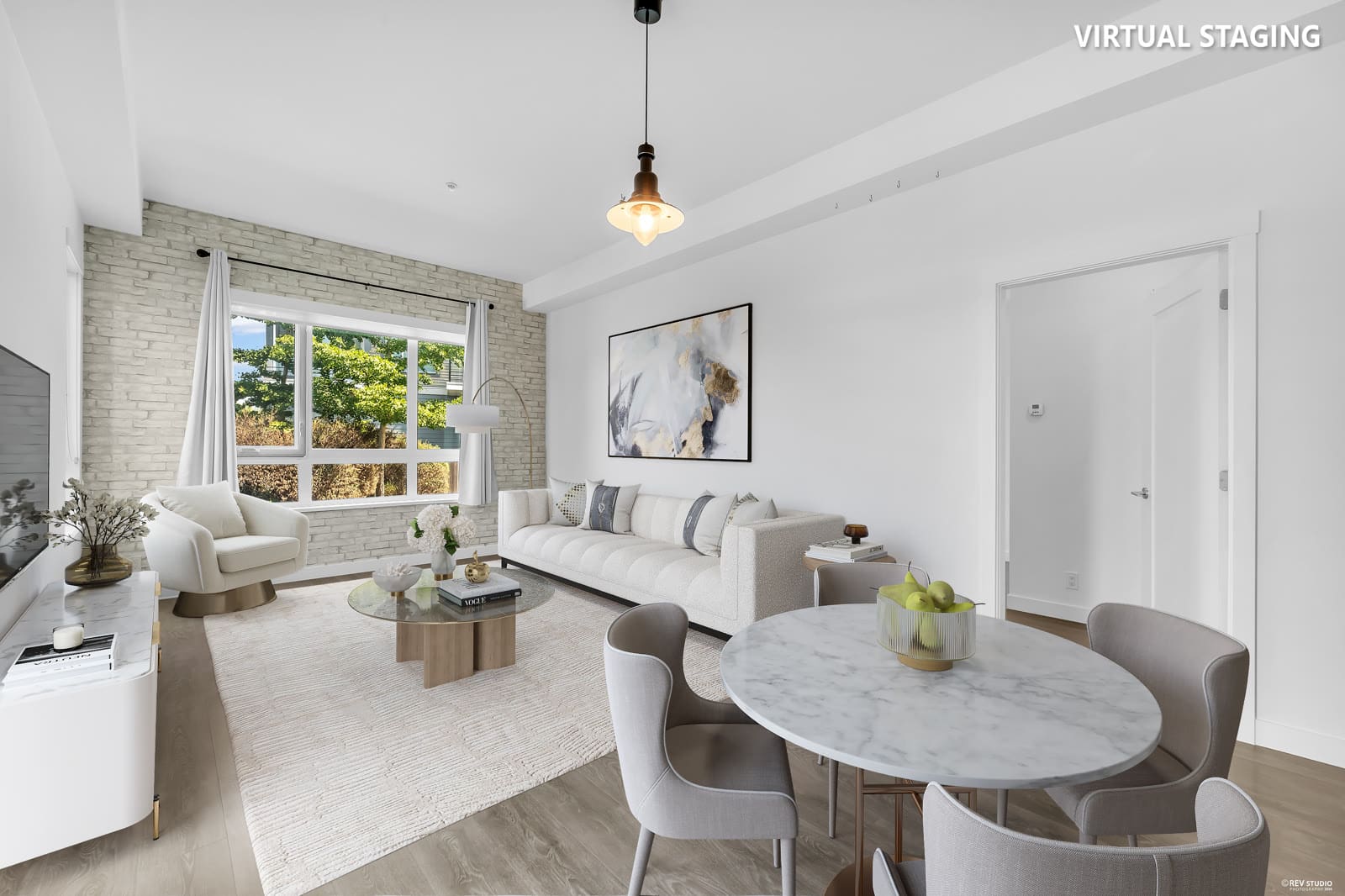 Virtually staged living and dining room by REV Studio — vacant space digitally furnished